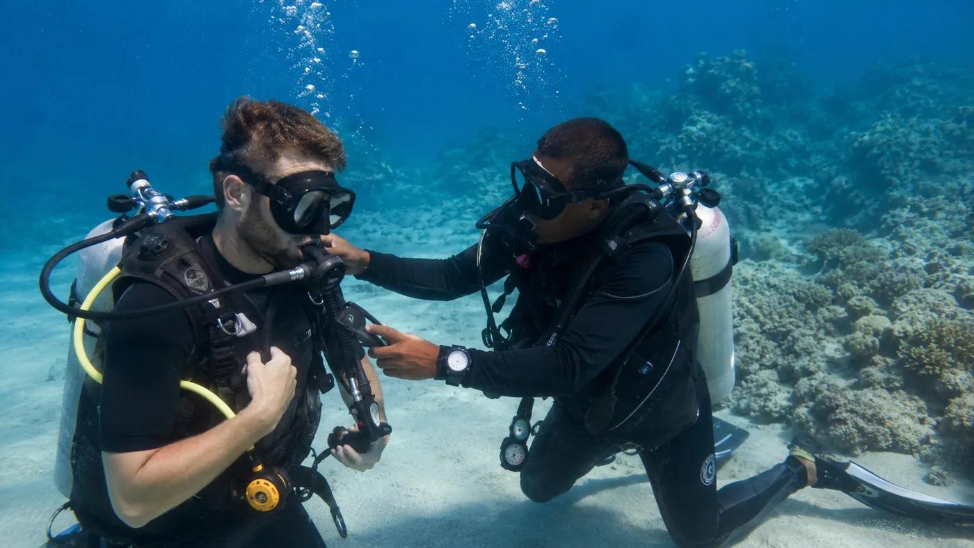 PADI instructor training a student diver underwater in the Red Sea